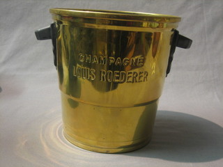 A polished brass twin handled wine cooler marked Champagne Louis Roedere