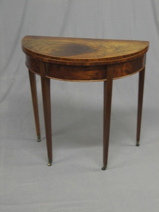 A Georgian mahogany D shaped card table, raised on square tapering supports, the top with crack, 32"