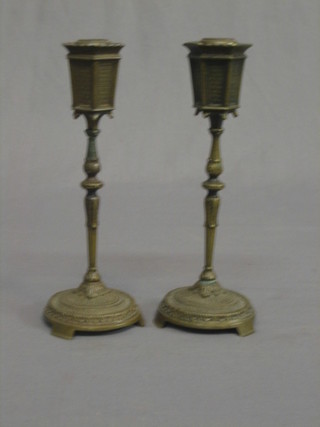 A pair of Continental bronze candlesticks in the form of street lights 8"