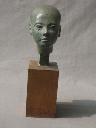 A 1930's plaster head and shoulder portrait bust of an ancient Egyptian, raised on a wooden base 9"