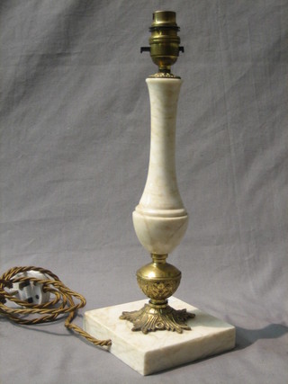 An onyx and gilt metal electric table lamp raised on a square base 11"