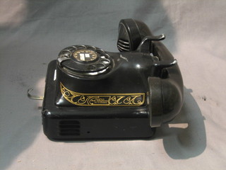 A 1950's bell wall mounting telephone contained in a metal case