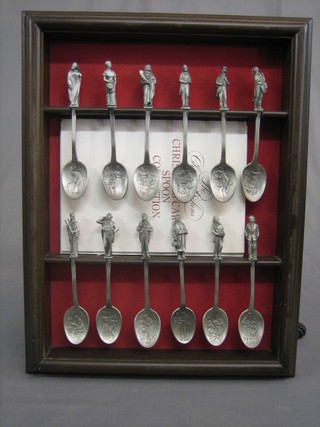 A set of 12 pewter spoons complete with display frame, each a Christmas Carol character