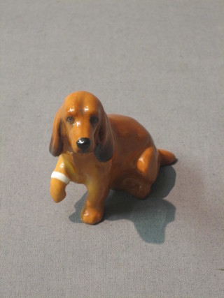 A Royal Doulton figure of a seated spaniel with bandaged paw, the base marked Royal Doulton BK9 2 1/2"