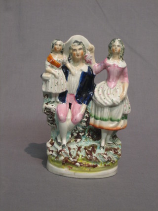 A 19th Century Staffordshire figure of a standing couple with child 9"