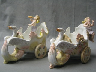 A pair of 19th Century style porcelain planters in the form of chariots with cherubs, 8"