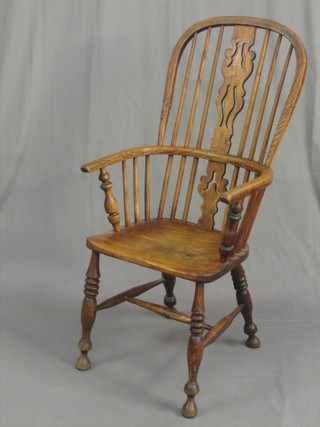 A 19th Century elm stick and splat back carver chair, raised on turned supports united by an H framed stretcher