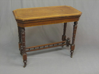 An Edwardian oak and mahogany card table of lozenge form with crossbanded top with ebony stringing, raised on turned supports united by H framed stretcher and bobbin turned decoration 36"