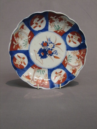 A Japanese Imari porcelain plate decorated a vase of flowers with panelled body and lobed border 8 1/2"