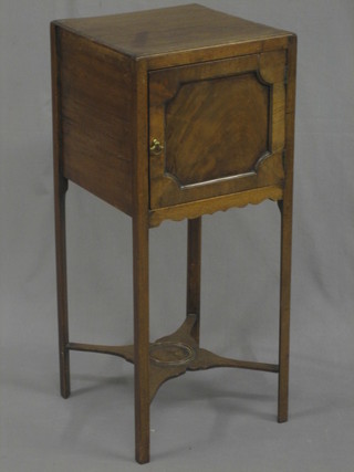 An 19th Century mahogany pot cupboard enclosed by a panelled door, raised on square tapering support and with an undertier 13"