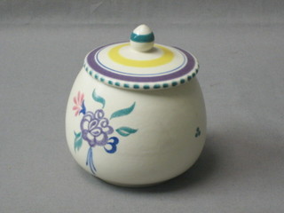 A circular Poole Pottery preserve jar and cover, base with Dolphin mark and impressed 288 3"