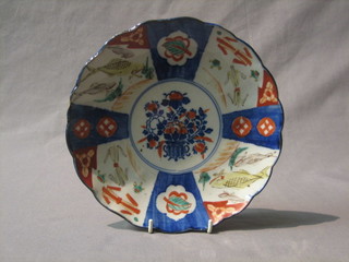 A circular Japanese Imari porcelain plate with panel decoration 8"