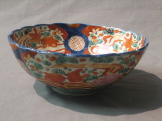 A circular Japanese Imari porcelain bowl decorated a vase of flowers 7"