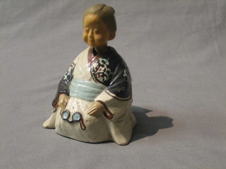 An Oriental porcelain figure of a seated nodding lady 4"