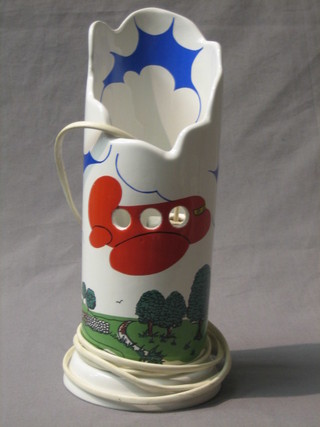 A Honiton pottery night light decorated an aircraft in  flight, the base impressed Honiton England 11"