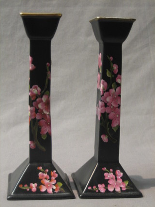 A pair of Carltonware black glazed pottery candlesticks with floral decoration 10"