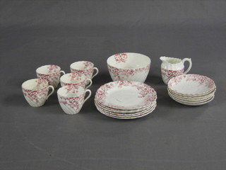A 19 piece red and white pattern tea service comprising 6 tea plates 7", 6 saucers, 5 cups, cream jug and a sugar bowl (rubbed)