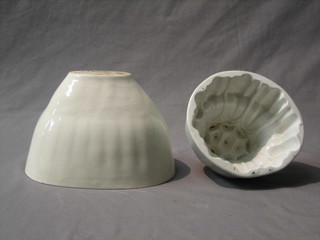 An oval white glazed shell patterned jelly mould 9" and a circular jelly mould 7"