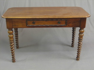 A Victorian oak side table fitted a drawer and raised on spiral turned supports 48"
