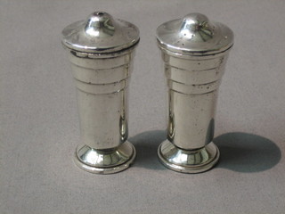An Art Deco style silver salt and pepper of cylindrical form (marks rubbed)