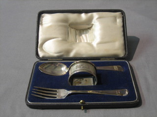 A silver 3 piece Christening set comprising napkin ring, spoon and fork, Birmingham 1951