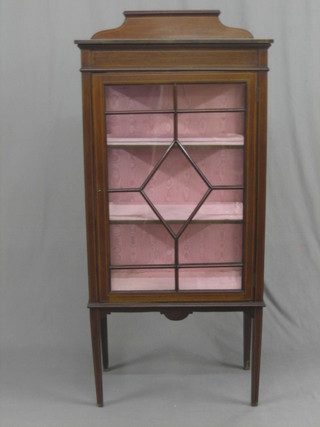 An Edwardian inlaid mahogany display cabinet the interior fitted shelves enclosed by glazed panelled doors, raised on square tapering supports 26"