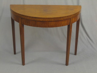 A 19th Century mahogany demi-lune card table, raised on square tapering supports 37"