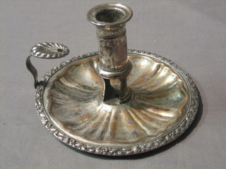 A circular silver plated chamber stick