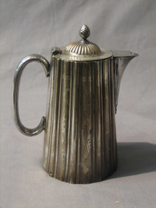A circular silver plated hotwater jug with demi-reeded decoration