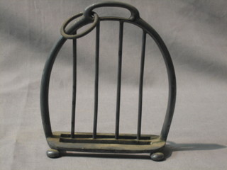 A novelty 4 bar silver plated toast rack in the form of a stirrup iron 