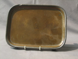 A 19th Century rectangular silver plated salver with armorial and cast decoration, raised on panel supports 10"