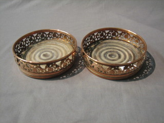 A pair of circular silver plated wine coasters