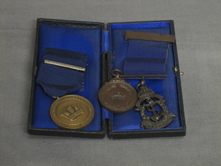 A bronze Royal Naval Rifle Association medal for Bisley and a 2 other bronze medals