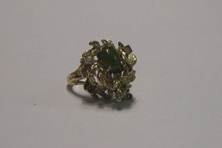 An Eastern 18ct pierced gold ring set green hardstones and white stones