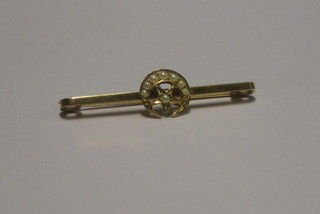 A 9ct gold bar brooch in the form of a crescent moon and set demi-pearls