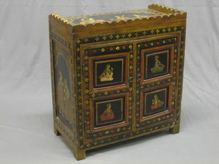 An Indian table top cabinet, fitted shelves and a drawer enclosed by a panelled door 23"