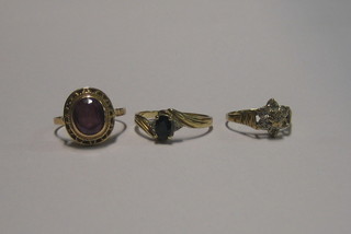 A modern 9ct gold dress ring set white stones, a gilt dress ring blue and white stones and a gilt dress ring set an oval pink cut stone