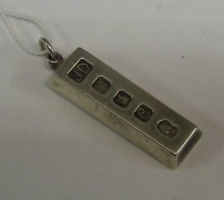 A 1977 silver ingot pendant
