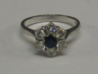 A lady's 18ct white gold dress ring set a blue stone supported by 6 diamonds