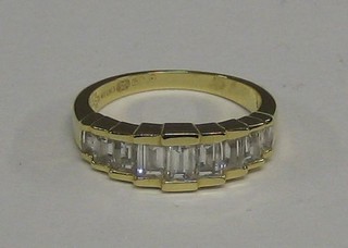A lady's modern 18ct gold dress ring set 9 baguette cut diamonds