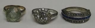 A lady's dress ring set a white stone, do. set a blue stone and an Art Deco multi coloured metamorphic eternity ring