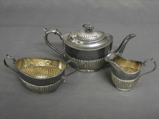 A Britannia metal 3 piece tea service of oval reeded form with teapot, twin handled sugar bowl and cream jug