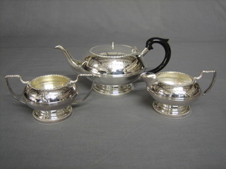 A silver plated 3 piece tea service with engraved decoration comprising teapot, twin handled sugar bowl and cream jug