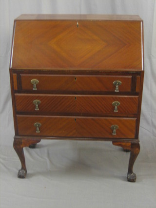 A 1930's Queen Anne style walnut bureau with fall front above 2 long drawers, raised on cabriole ball and claw supports 29"