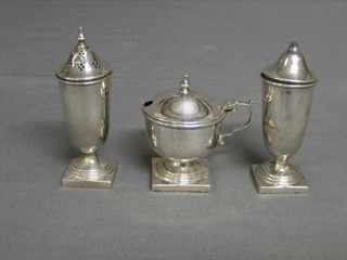 An Art Deco 3 piece silver condiment set comprising mustard pot, pepper and salt, raised on square bases, Sheffield 1935 with Jubilee mark, 5 os