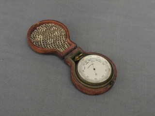 A pocket barometer contained in a leather case