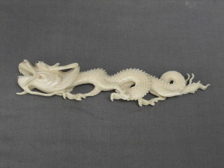 An Eastern carved ivory figure of a dragon 8"