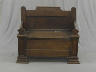 An oak settle with hinged lid to the seat 49"