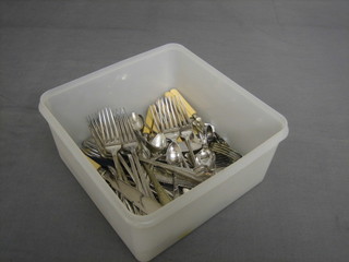 A pair of silver sugar tongs and a collection of silver plated flatware 