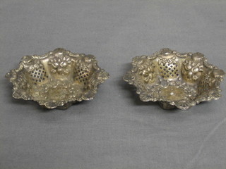 A pair of circular embossed and pierced silver dishes 3"